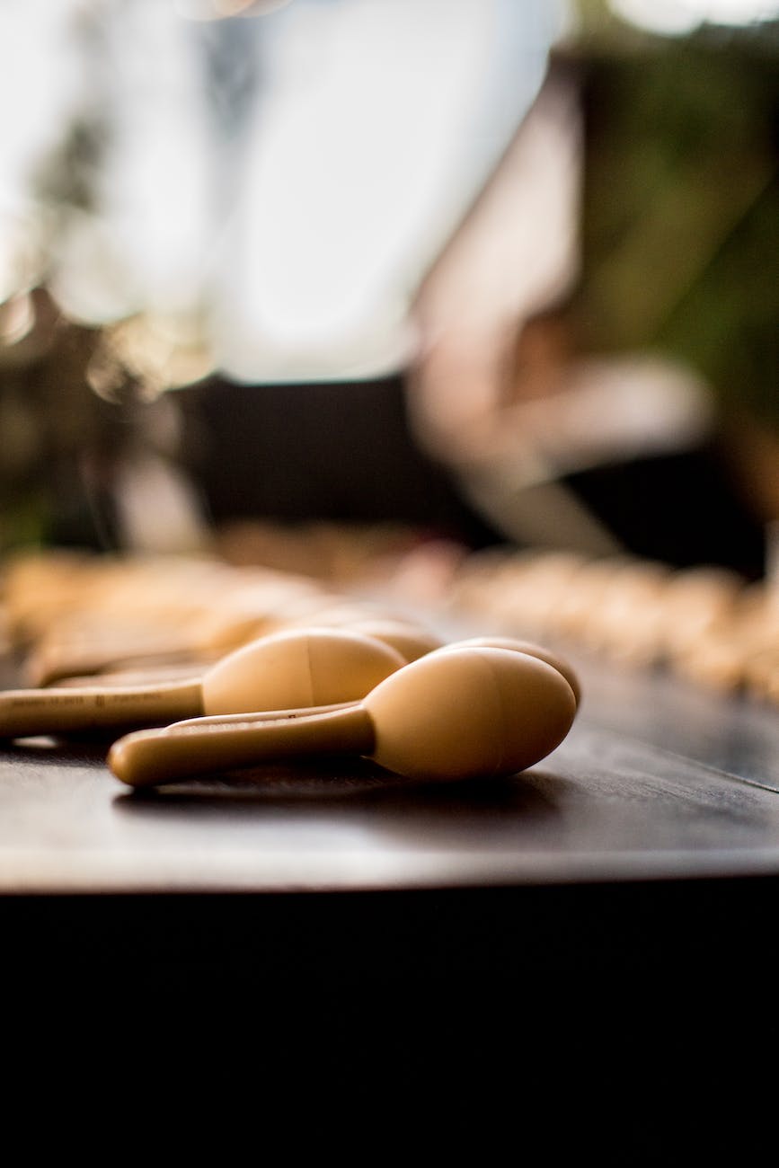 smalll, wooden maracas lie in rows across a table